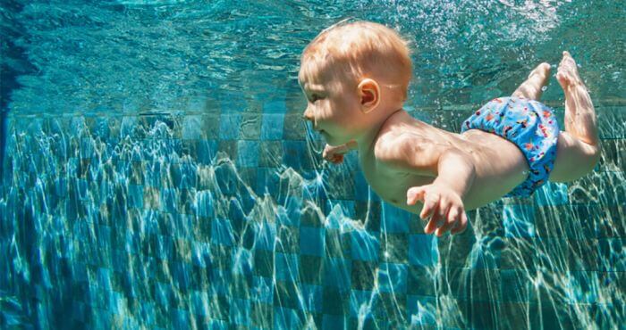 toddler swimming under water