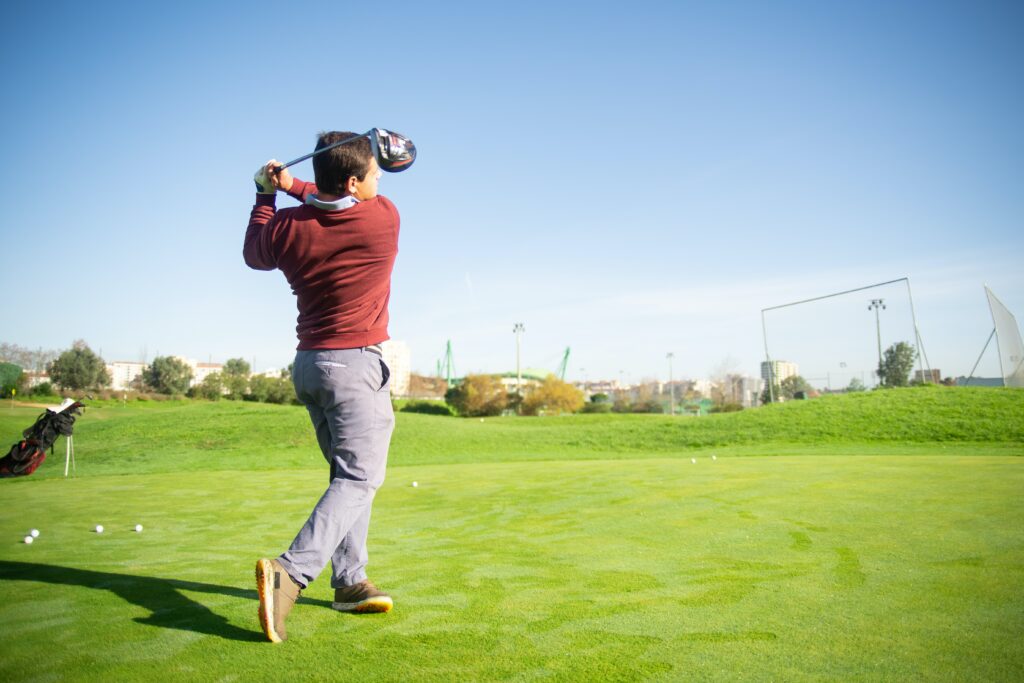 man hitting golf balls