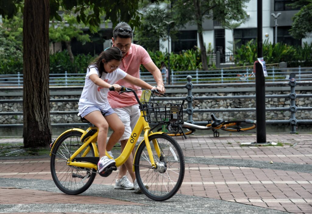 man and girl on bike