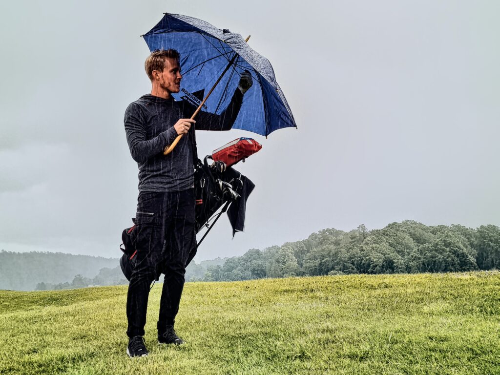 man with golf umbrella