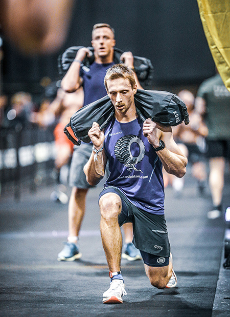 man sandbag lunging