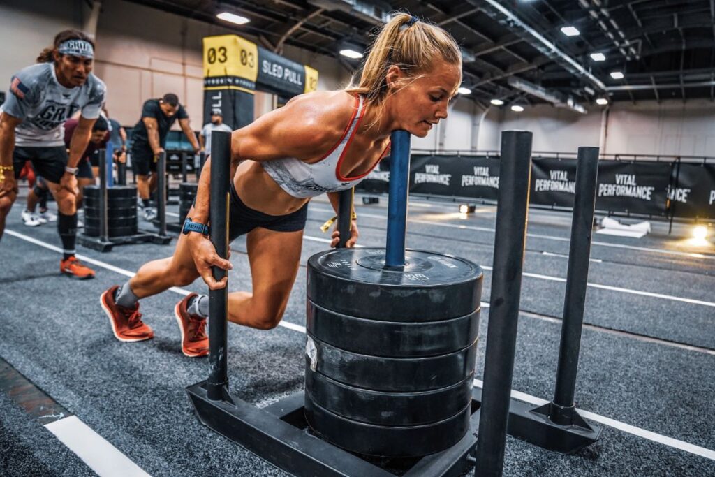 woman pushing sled